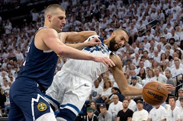 Rudy Gobert of the Minnesota Timberwolves, right, is defended by Nikola Jokic of the Denver Nuggets in the first quarter on Sunday.