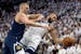 Rudy Gobert of the Minnesota Timberwolves, right, is defended by Nikola Jokic of the Denver Nuggets in the first quarter on Sunday.