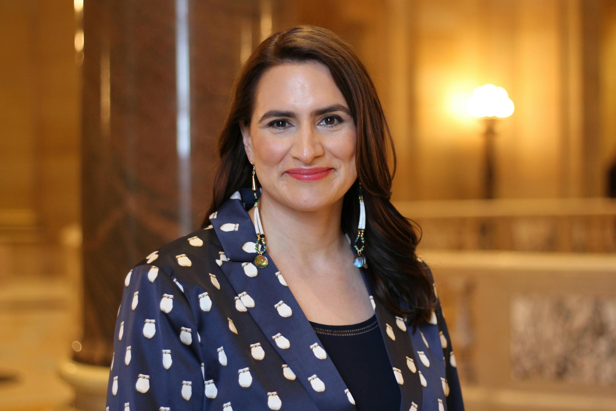 For her new official headshot, Lt. Gov. Peggy Flanagan wore a contemporary suit with an elk teeth pattern. The suit was designed by Los Angeles-based Bethany Yellowtail (Northern Cheyenne). Earrings from Avis Charley (Dakota/ Diné, Instagram: @avischarley).
