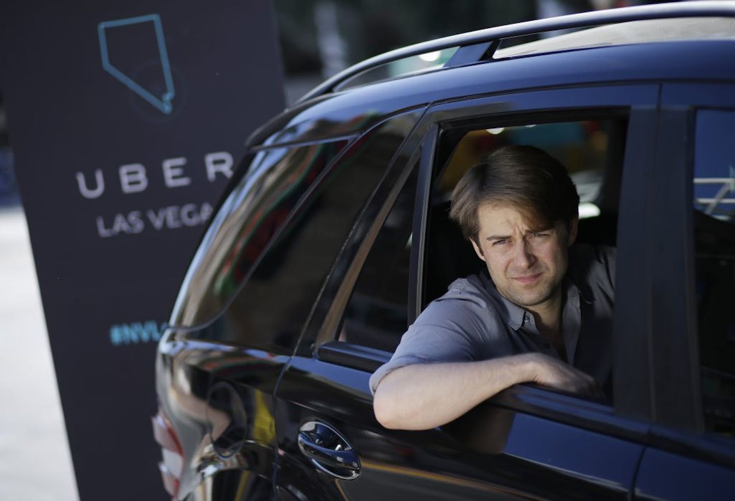 Uber West Coast Regional Manager William Barnes sits in the back of a car during a photo shoot Friday, Oct. 24, 2014, in Las Vegas. The ride sharing company has begun operations in Nevada.