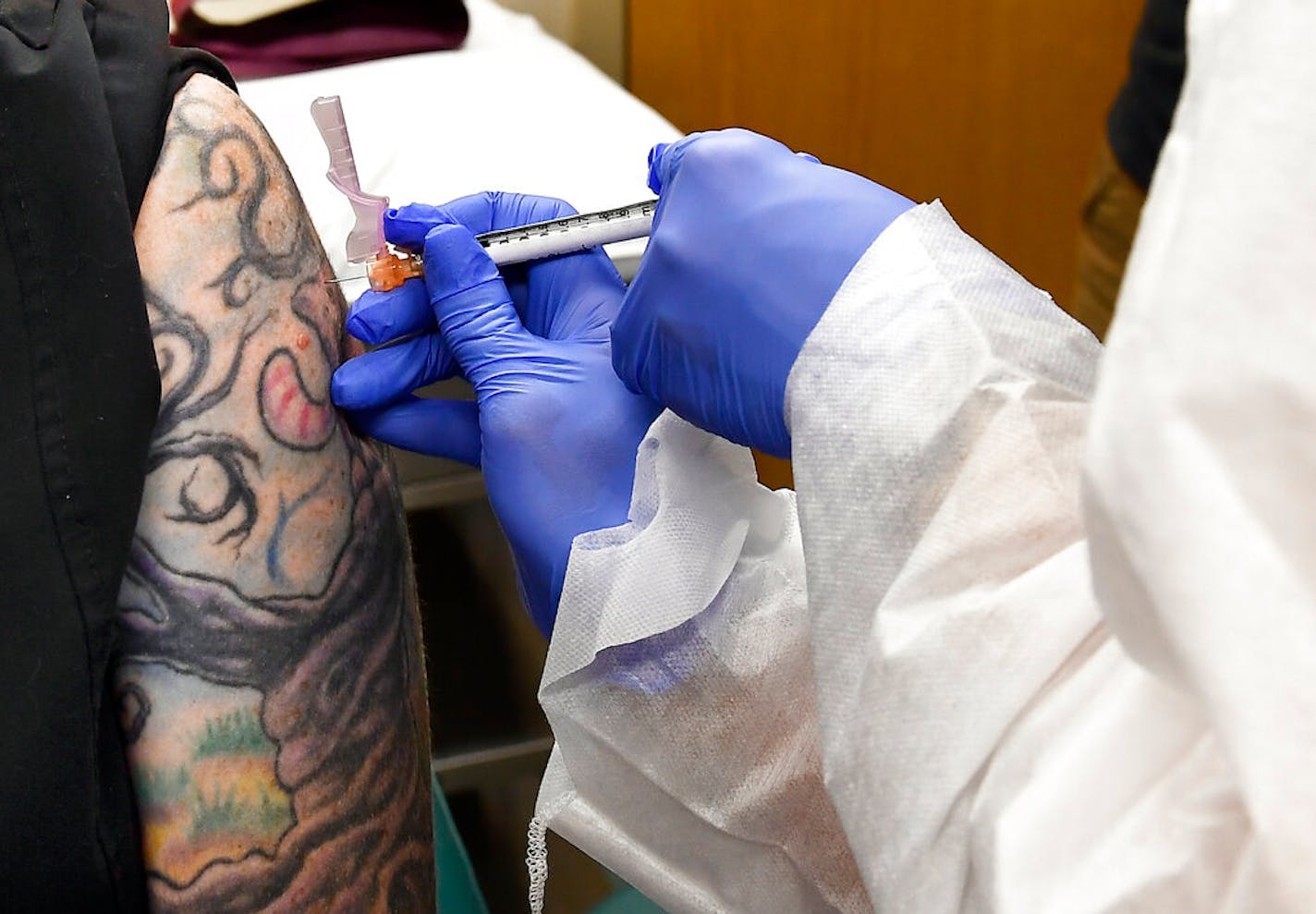 Nurse Kathe Olmstead gave volunteer Melissa Harting, of Harpersville, N.Y., an injection as a study of a possible COVID-19 vaccine, developed by the National Institutes of Health and Moderna Inc.