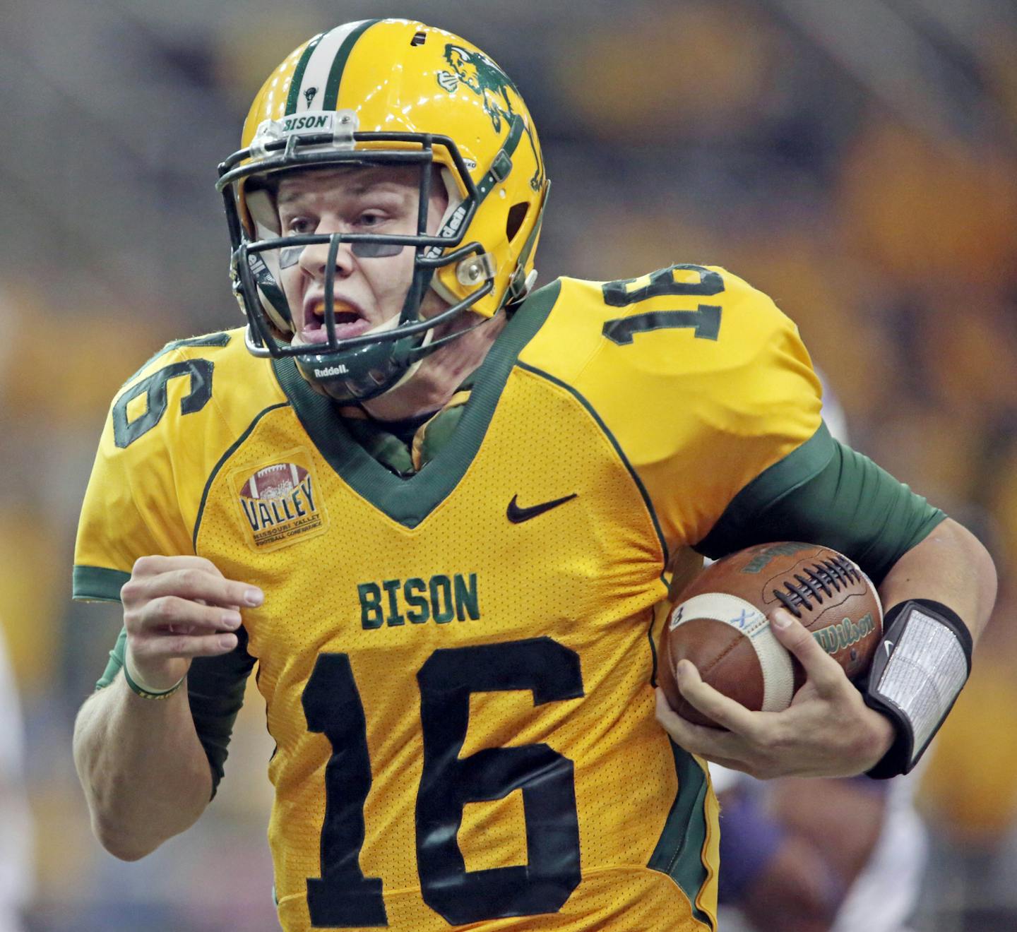 North Dakota State quarterback Brock Jensen heads upfield on a 53-yard touchdown carry against Furman Saturday, Dec.7, 2013, during the second round of the FCS playoffs at the Fargodome in Fargo, N.D. (AP Photo/ The Forum, David Samson)