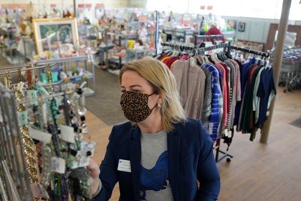 Sarah Colvin, a personal shopper at Arc Value Village in Richfield, searched for accessories for a client last week. 