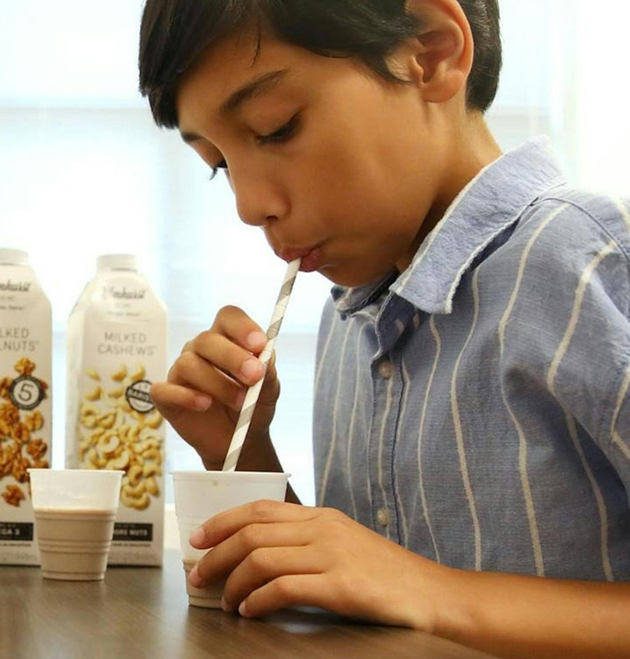 Eleven-year-old Mathieu Bui of Chicago drinks 90 milliliters of walnut milk and cashew milk as part of a treatment to eliminate his allergies at Kenilworth Medical Associates on Wednesday, Sept. 18, 2019 in Kenilworth, Ill. Bui has allergies to five tree nuts, including peanuts, walnuts, pecans, cashews and pistachios. In March of 2018 he began undergoing treatment to be desensitized to these nuts under the medical care of Dr. Paul Detjen. He is already able to eat peanuts and is expected to be