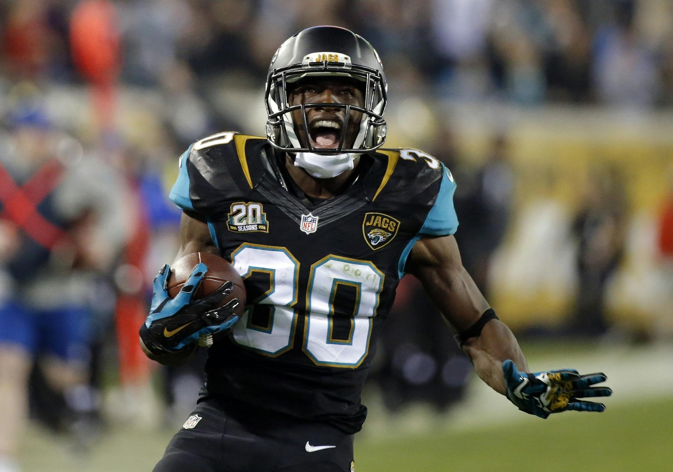 Jacksonville Jaguars running back Jordan Todman reacts as he runs 62-yard for a touchdown against the Tennessee Titans during the fourth quarter of an NFL football game Thursday, Dec. 18, 2014, in Jacksonville, Fla. (AP Photo/Stephen B. Morton)