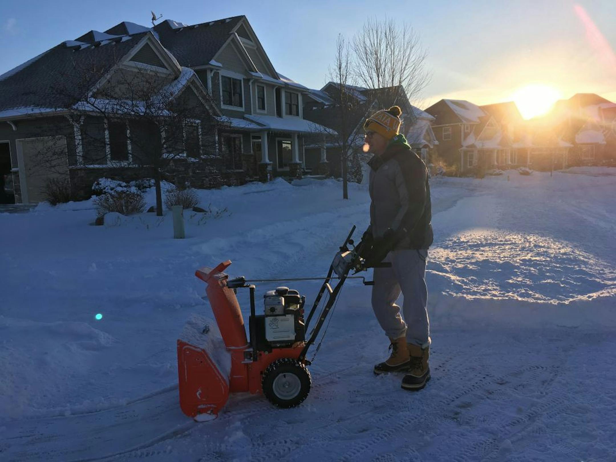 Mike Schlecht cleaned off his property in Maple Grove on Tuesday for the second time after a snowstorm dumped several inches over the metro area.