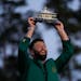 Jon Rahm, of Spain, celebrates holding the Masters trophy winning the Masters golf tournament at Augusta National Golf Club on Sunday, April 9, 2023, 