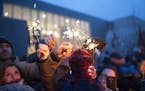 The crowd lights their sparklers from one another at the Winter Solstice celebration at the American Swedish Institute on Dec. 22, 2015.
