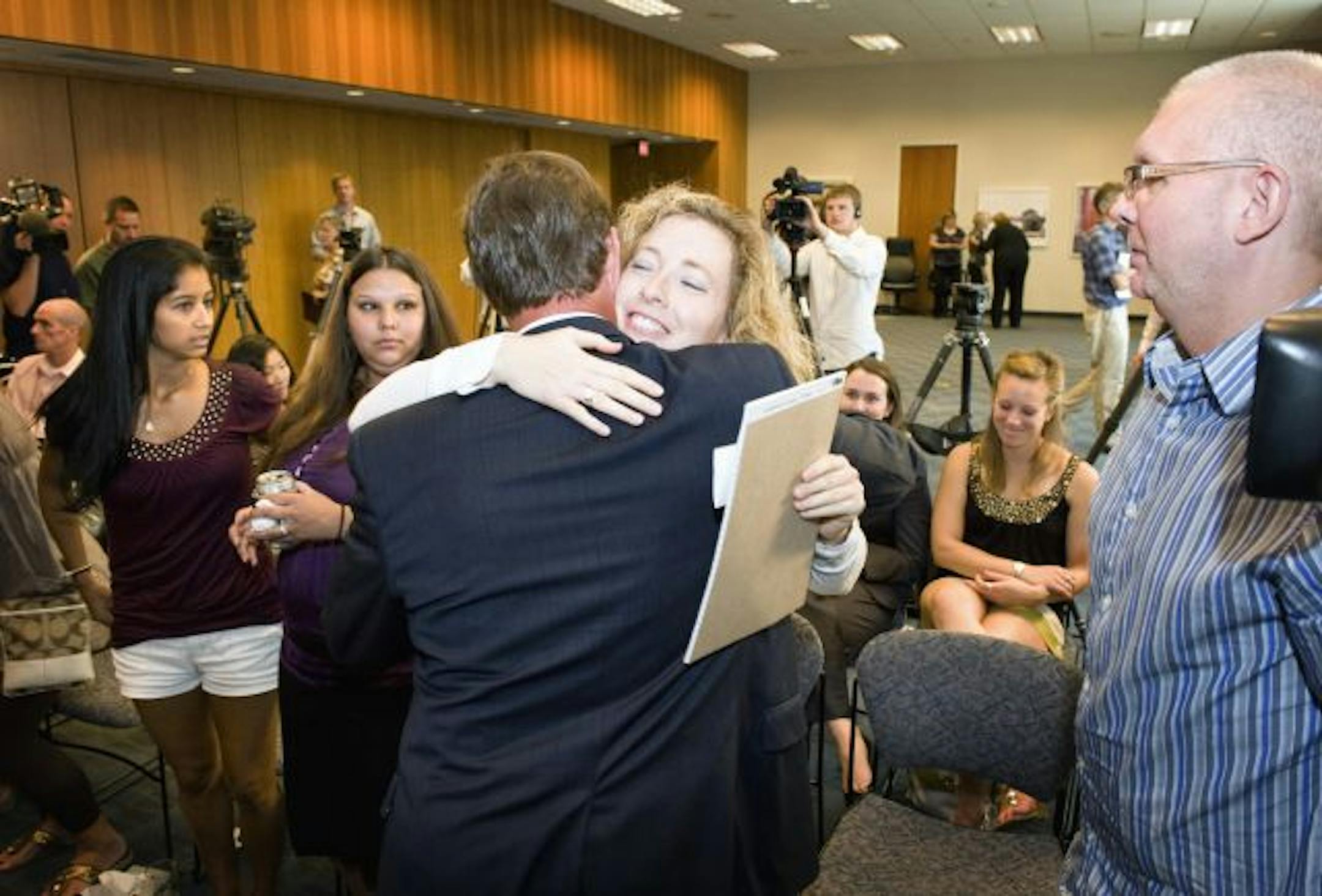 Attorney Chris Messerly and collapse victim Erica Gwillim embraced after the settlement announcement.