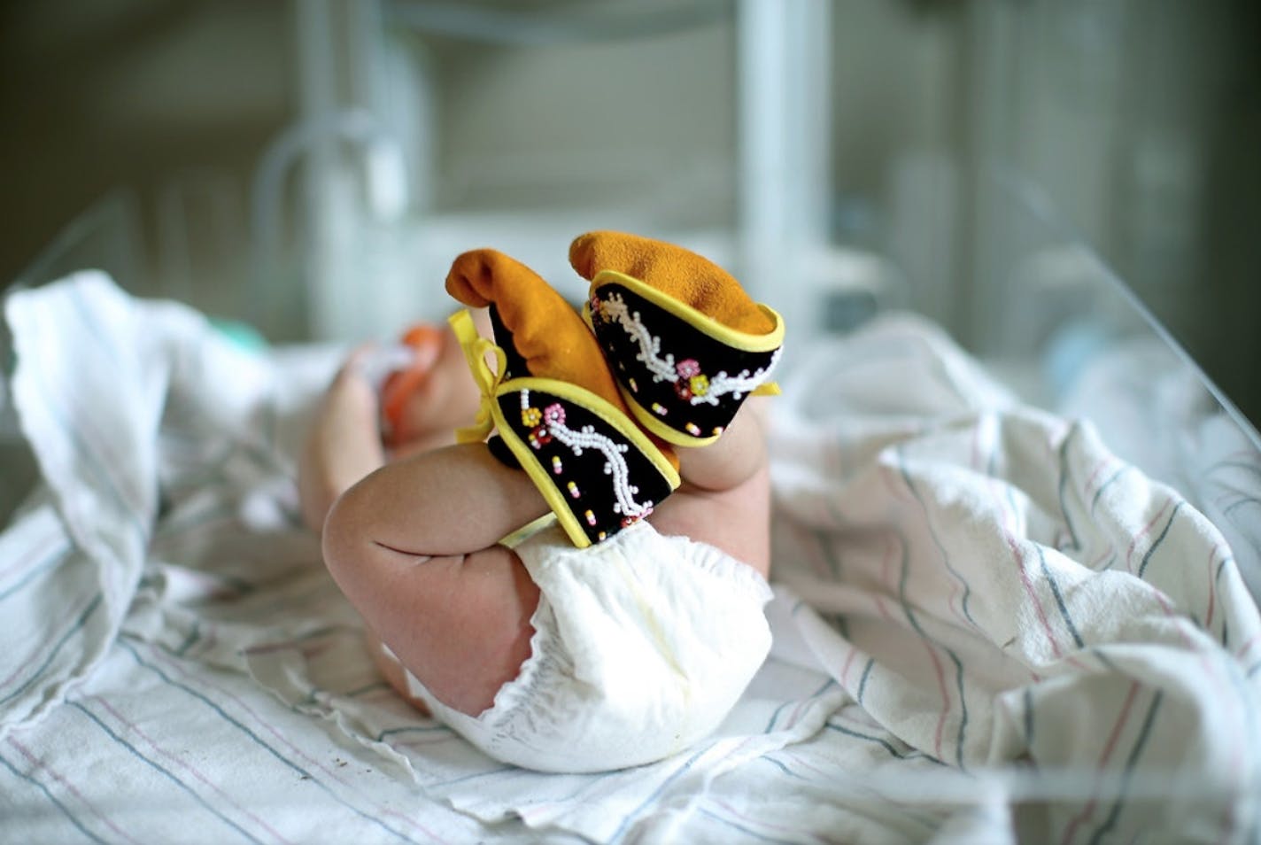 Volunteers at Two Rivers Art Gallery in Minneapolis hand-stitch and bead traditional moccasins as a gift of love to babies.