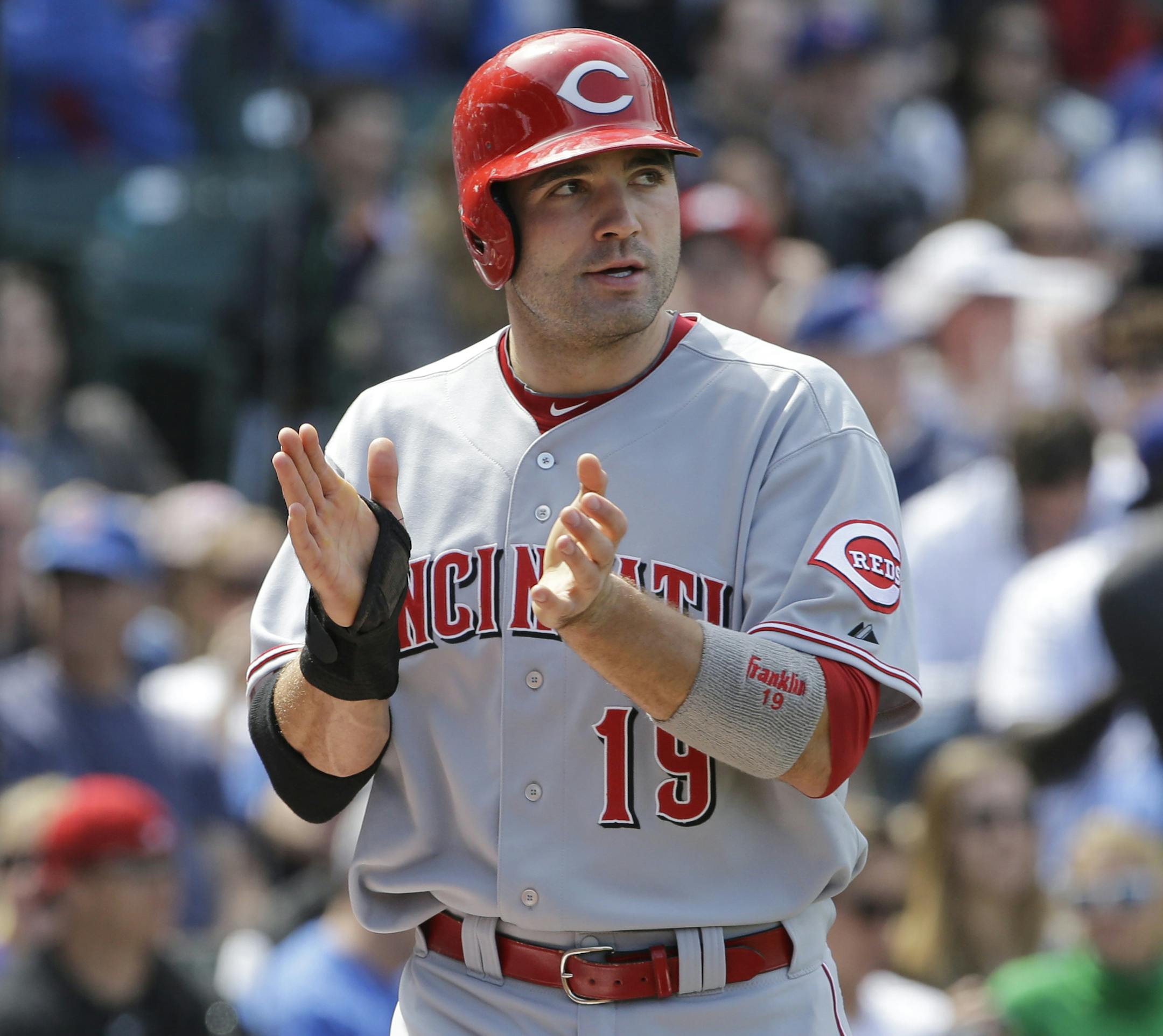 Cincinnati Reds' Joey Votto celebrates after scoring on a sacrifice fly hit by Todd Frazier during the eighth inning of a baseball game against the Chicago Cubs in Chicago, Saturday, May 4, 2013. The Reds won 6-4. (AP Photo/Nam Y. Huh)