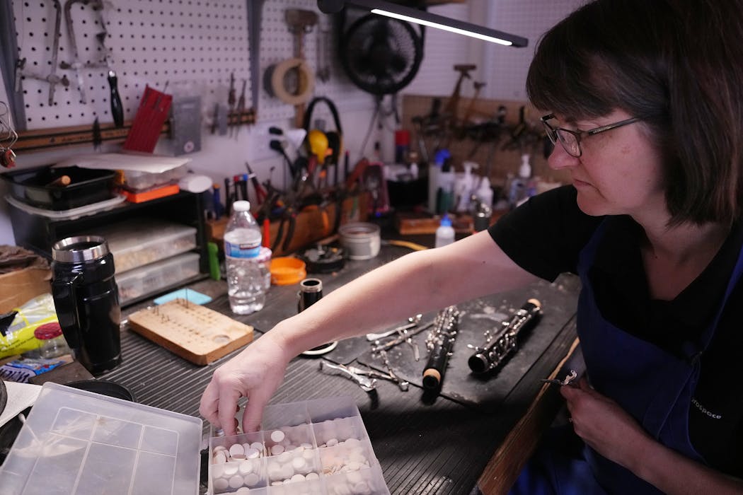 Michelle Paska re-pads a clarinet Tuesday in the repair department at Schmitt Music’s new flagship store in Bloomington.