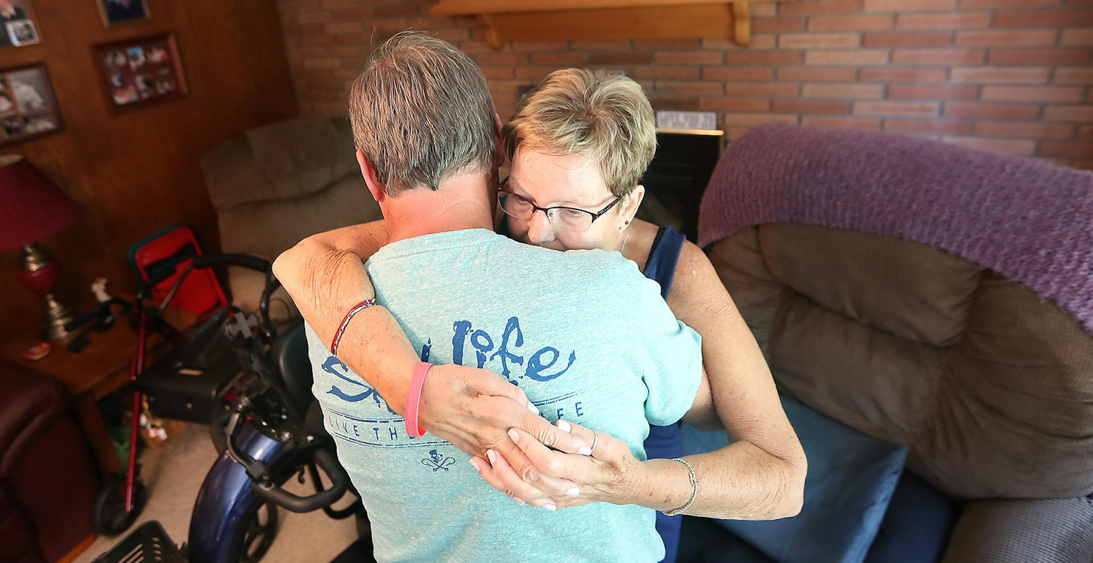 Jerry Leight helped lift his wife Linda Leight up so that she could get into her motorized scooter for some time outside, Friday, July 29, 2016 in New Brighton, MN. Linda, who was diagnosed with ALS three years ago, received the scooter through the ALS Ice Bucket Challenge. The motorized scooter has enabled Leight to live a more independent life. Now, Linda and Jerry can go on walks and do other activities outside the home. ] (ELIZABETH FLORES/STAR TRIBUNE) ELIZABETH FLORES &#x2022; eflores@star