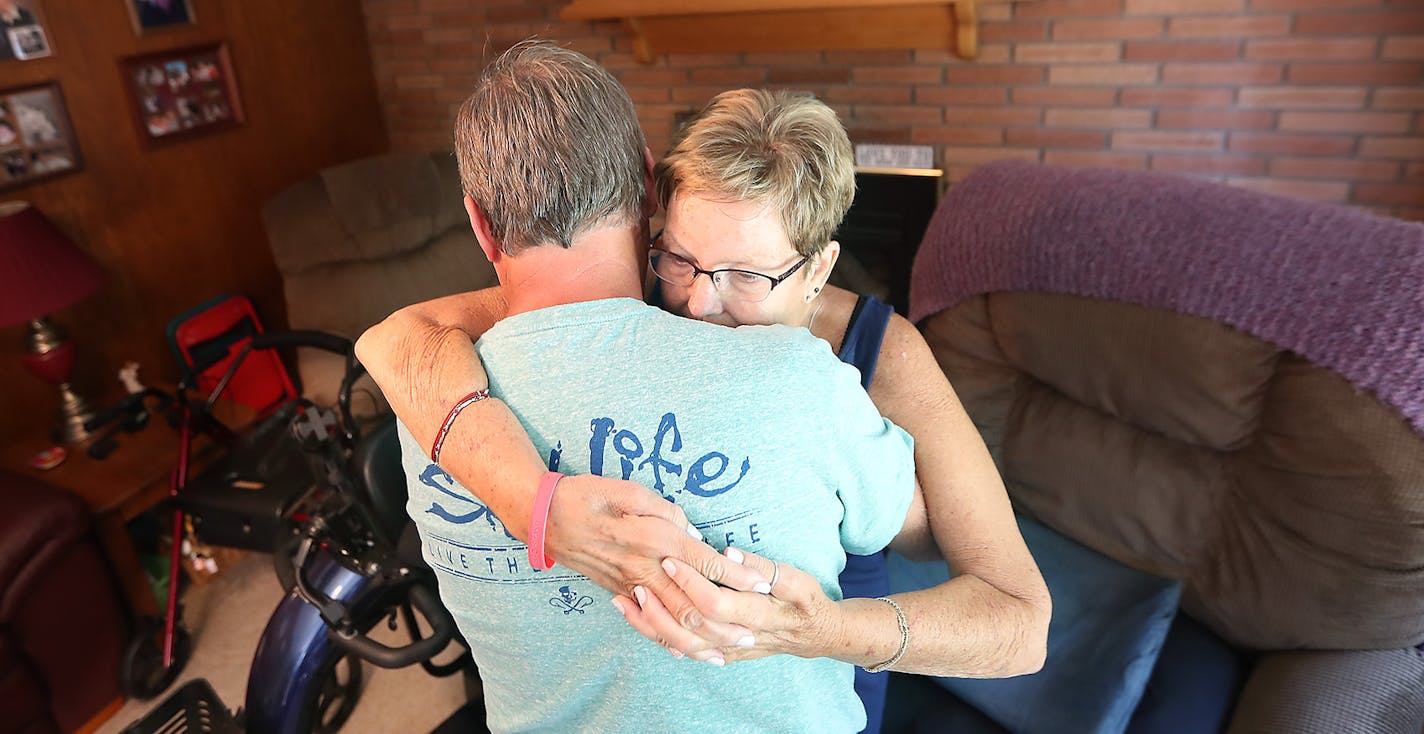 Jerry Leight helped lift his wife Linda Leight up so that she could get into her motorized scooter for some time outside, Friday, July 29, 2016 in New Brighton, MN. Linda, who was diagnosed with ALS three years ago, received the scooter through the ALS Ice Bucket Challenge. The motorized scooter has enabled Leight to live a more independent life. Now, Linda and Jerry can go on walks and do other activities outside the home. ] (ELIZABETH FLORES/STAR TRIBUNE) ELIZABETH FLORES &#x2022; eflores@star