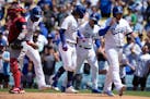 Los Angeles Dodgers' James Outman, center, Jason Hayward, second from left, Miguel Vargas (17), and Max Muncy (13) after they all scored off of a gran