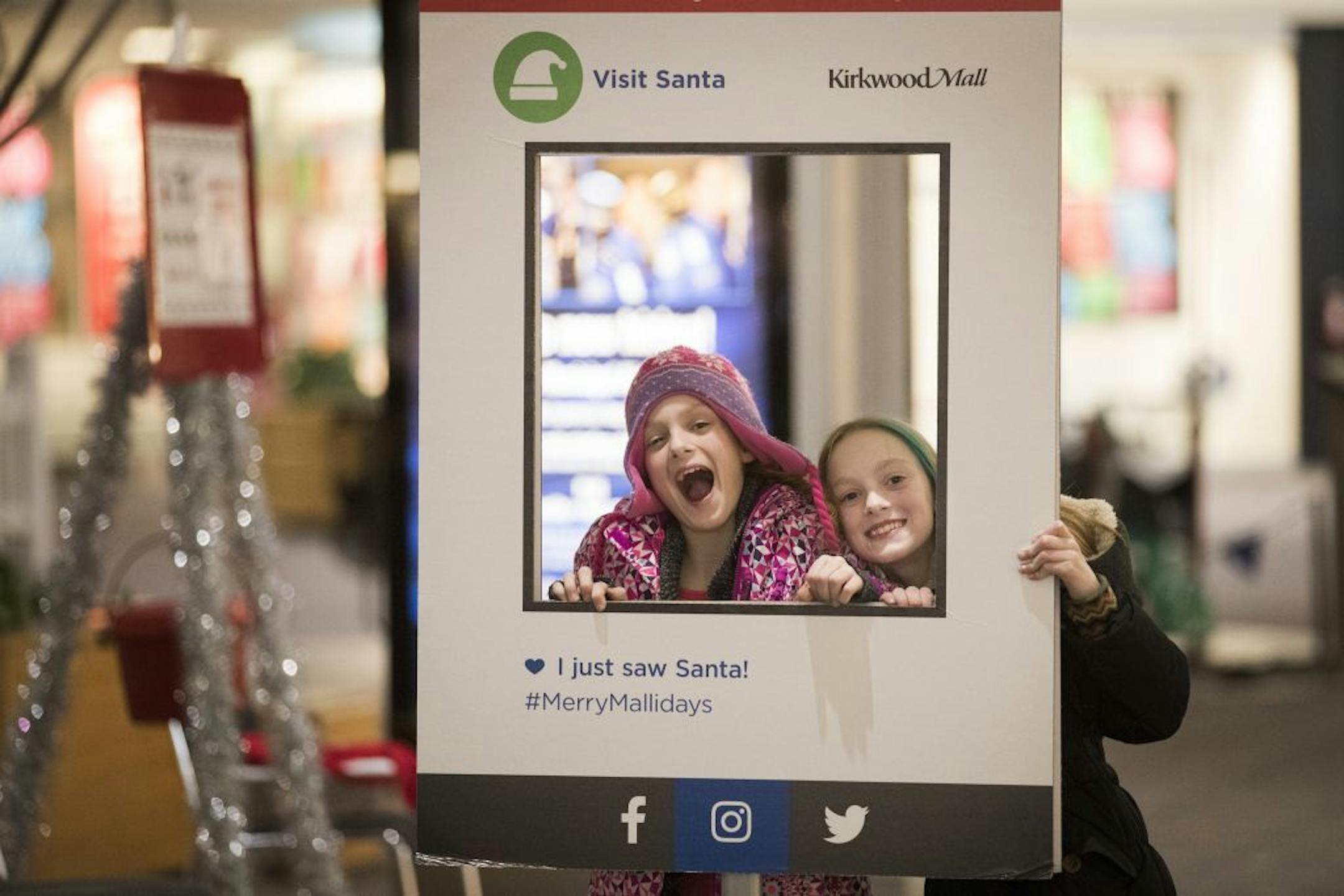 Isabelle, left, and Abby Carlsen pose for a photo at Kirkland Mall in Bismarck while shopping with their parents.