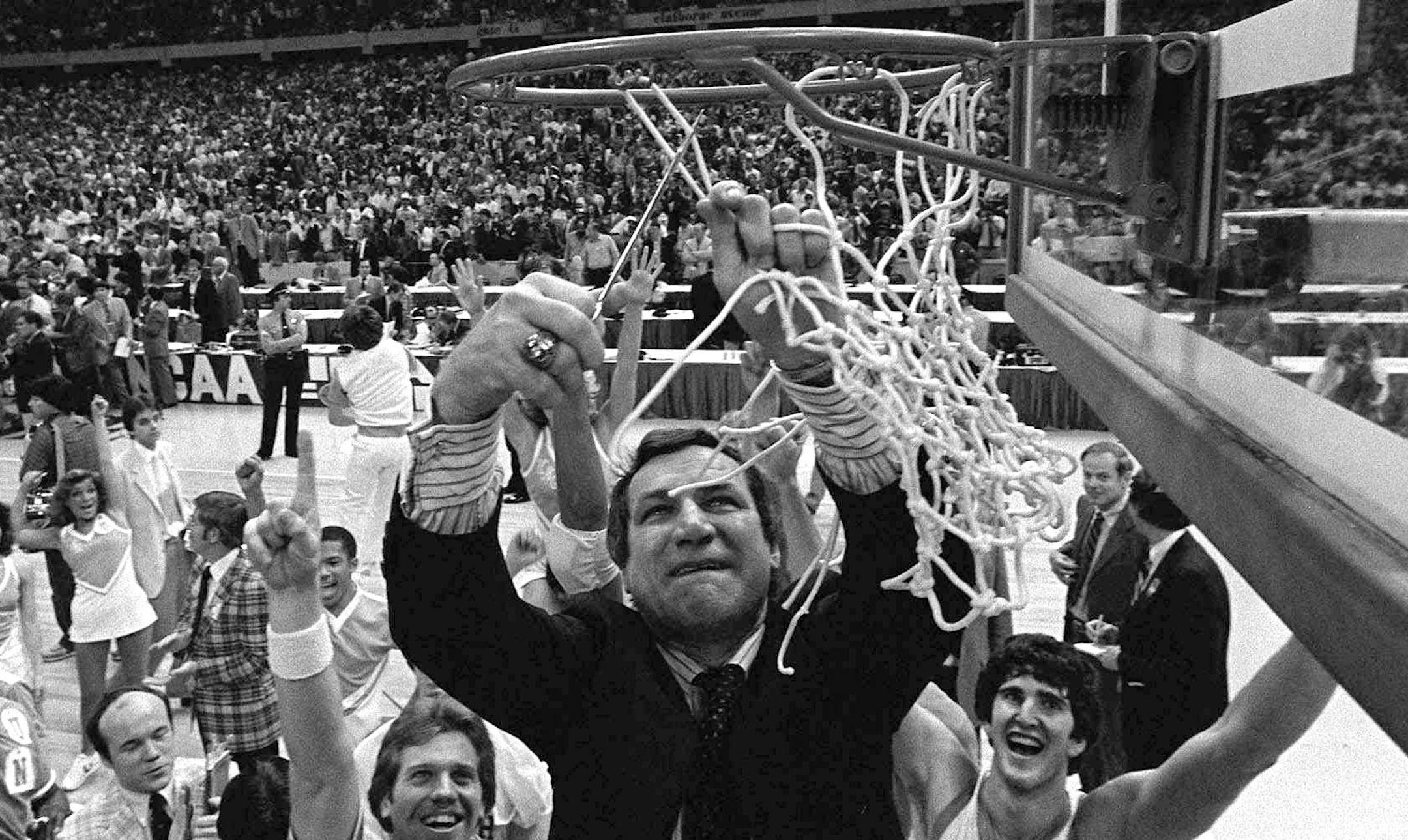 North Carolina basketball coach Dean Smith cuts the net as happy players and fans cheer after the Tar Heels defeated Georgetown for the NCAA Championship March 29, 1982 in New Orleans. (AP Photo/Pete Leabo) ORG XMIT: NY54,NY54