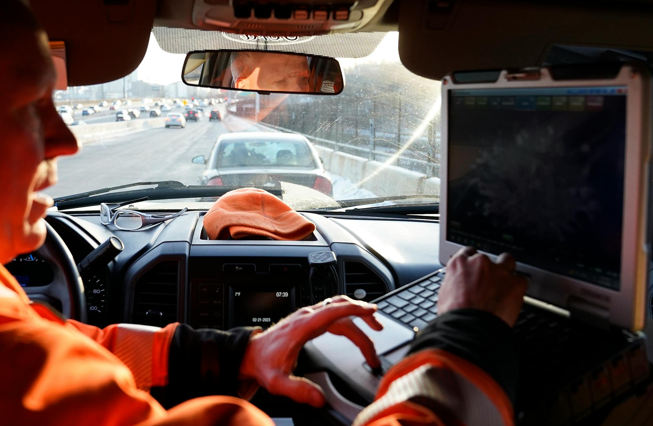 Mike Ahlman, a driver for MnDOT's Freeway Incident Response Safety Team, input information in his computer near where a motorist had pulled over and parked on a ramp along Interstate 394 in a dangerous spot.