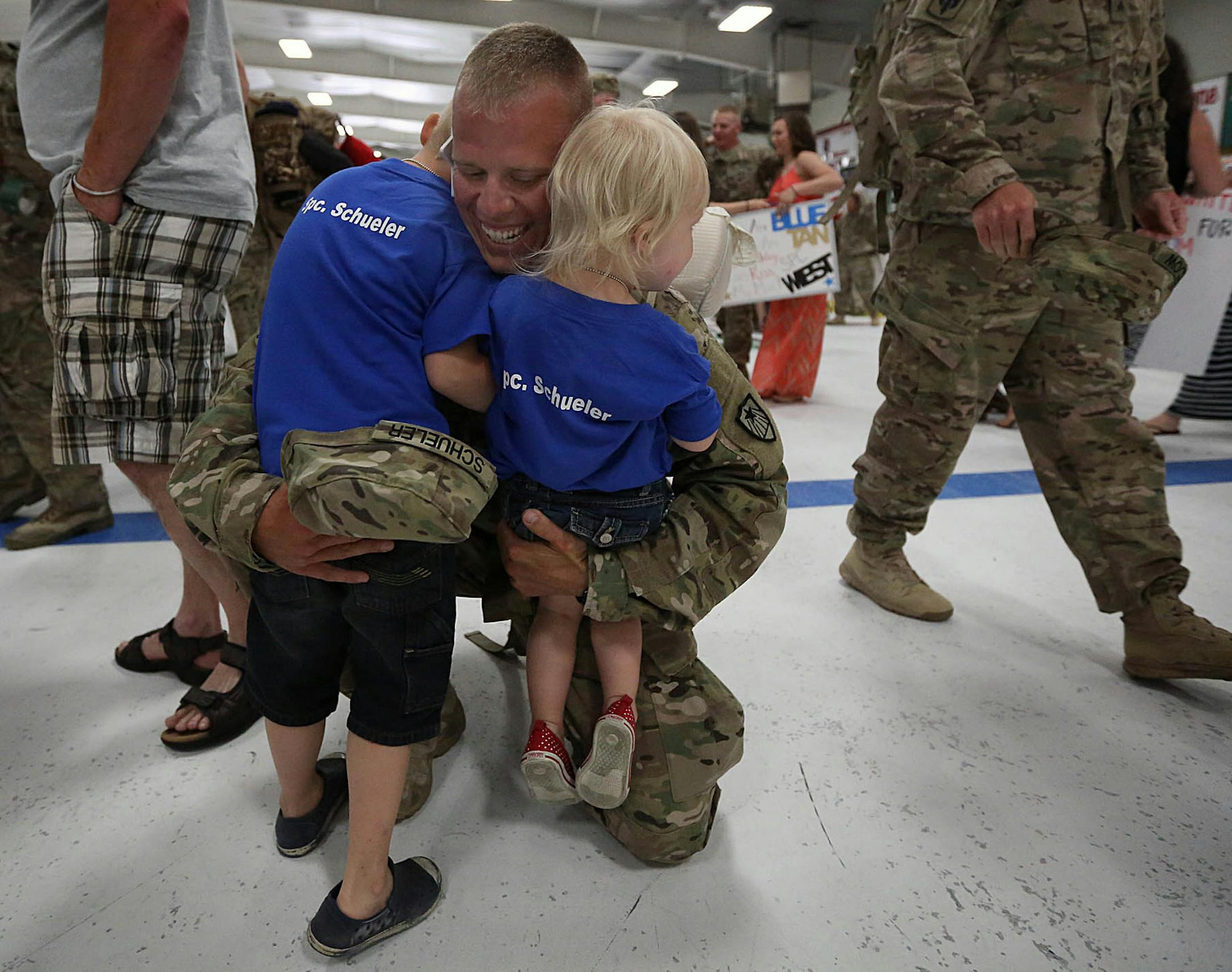 Ellie, 2 ¬Ω (right) and Colton Schuler, 5, ran into the arms of their father, Specialist Jordan Schuler, St. Cloud, after he returned from an 11-month deployment to Afghanistan.