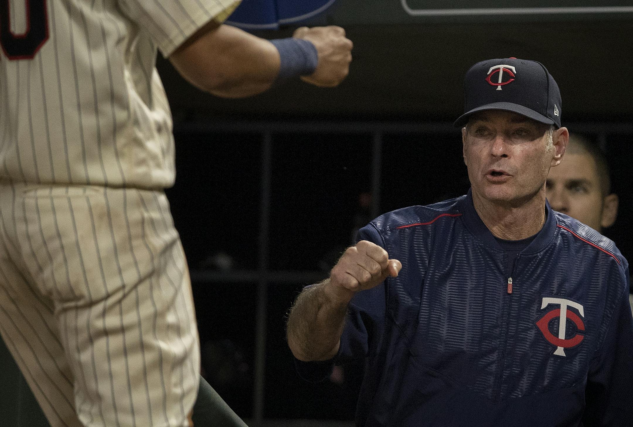 Eddie Rosario was greeted by manager Paul Molitor after scoring in the second inning.