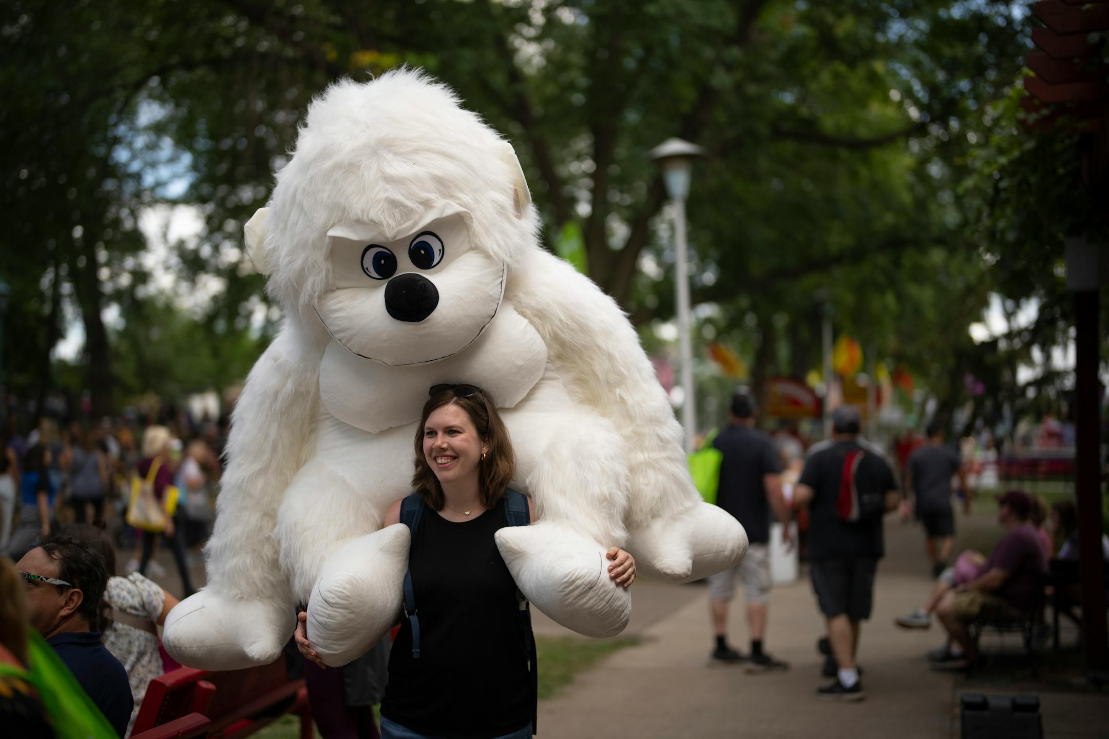 Alex Brown attracted some attention with the enormous Yeti she won at the bottle stand up booth on the first day of the Minnesota State Fair August, 25, 2022 in Falcon Heights. "It was the last ticket I had," she said. "I win every year. I either give it to a kid or donate it someplace. This is the biggest one I've ever won! It's fun to win but it's more fun to give them away."