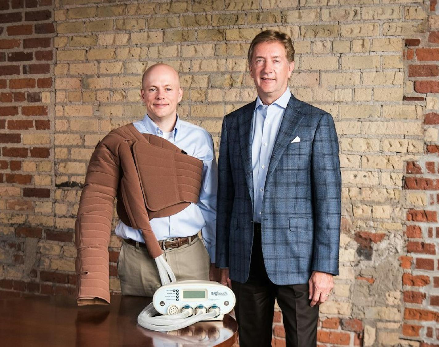 Tactile Medical systems executive Wade Zander and CEO Jerry Mattys (right) demonstrate a compression device. 2017 Tactile photo by: Stefan Iwaskewycz