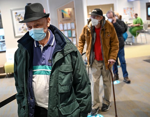 Patients, including Gerald Sweeney, 79, waited in line to be vaccinated at North Memorial's Minnetonka Medical Center on Tuesday afternoon.