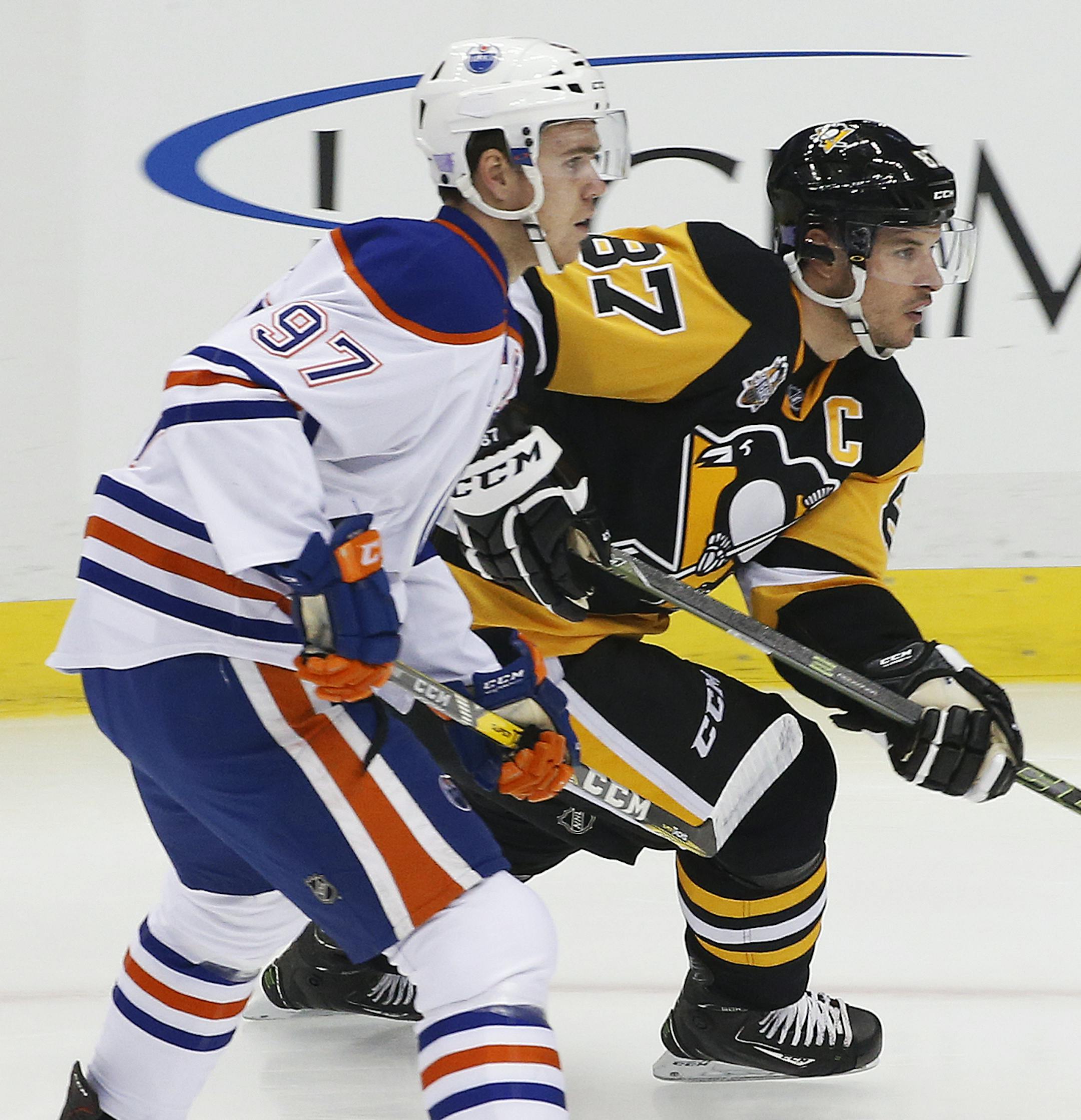Edmonton Oilers' Connor McDavid (97) and Pittsburgh Penguins' Sidney Crosby (87) skate during the first shift of the first period of an NHL hockey game in Pittsburgh, Tuesday, Nov. 8, 2016. (AP Photo/Gene J. Puskar) ORG XMIT: PAGP110