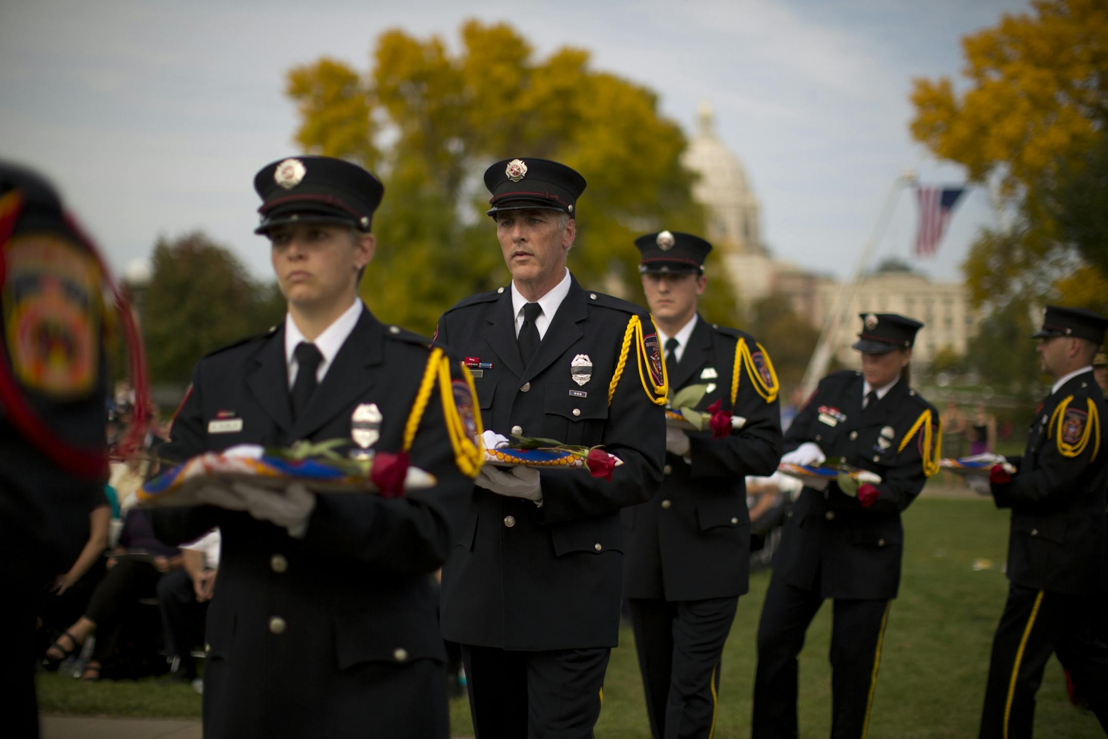 Minnesota firefighters marched with folded state flags and roses that were presented to family members or representatives of the 207 firefighters who have died in the line of duty since 1881. An annual service will be held at the memorial on the last Sunday in September.