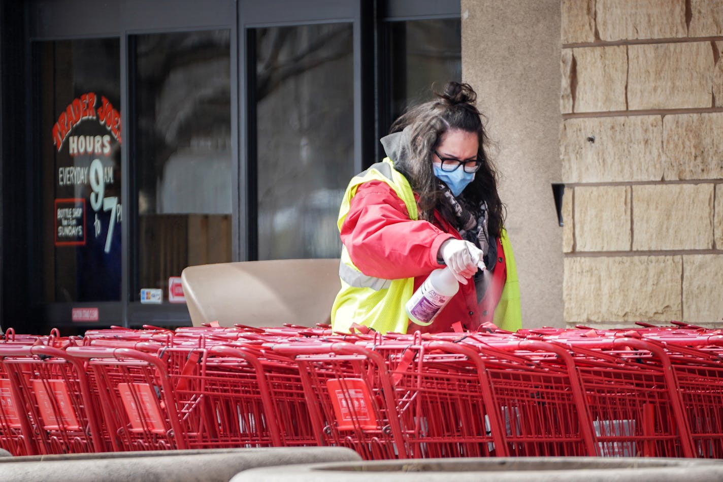 Kyra Clapp disinfected shopping carts after each use at Trader Joe's in Bloomington.