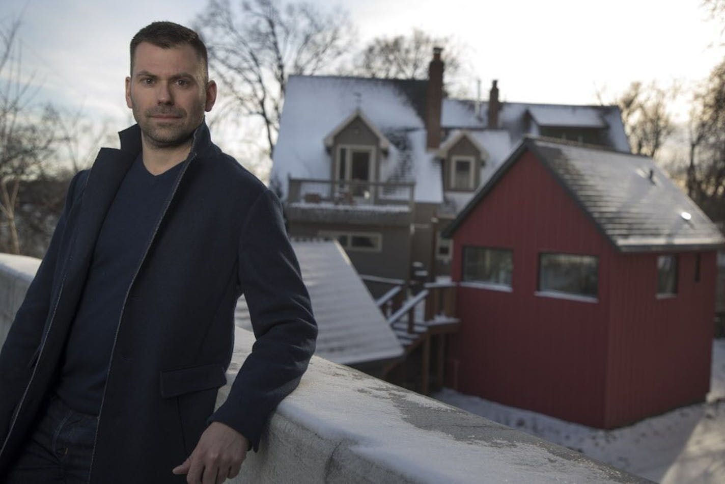 Homeowner Eric Tollefson had a small accessory dwelling unit (ADU) built next to home in Linden Hills. He rents the ADU on Airbnb to generate income he can use to fund future remodeling of his century-old home. The red ADU is at right, with the primary home behind it.