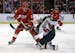 Detroit Red Wings defenseman Kent Huskins (3) and Minnesota Wild center Mikael Granlund (64), battle for the puck during the first period of an NHL ho