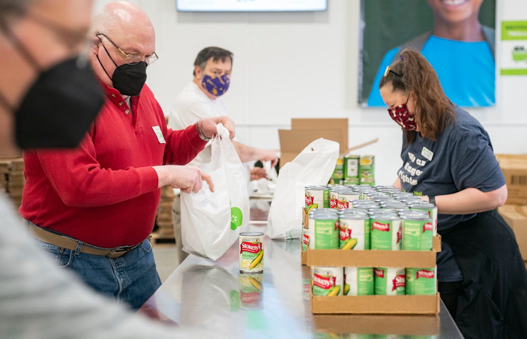 Volunteers took food — such as canned fruit and crackers — from pallets that Every Meal purchases and divided it up into bags that are distributed to local schools.