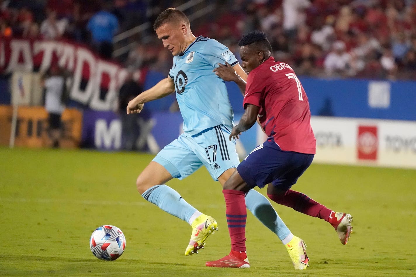 Minnesota United midfielder Robin Lod (17) pulls away from FC Dallas forward Jader Obrian (7) during the first half of an MLS soccer match Saturday, Oct. 2, 2021, in Frisco, Texas. (AP Photo/LM Otero)