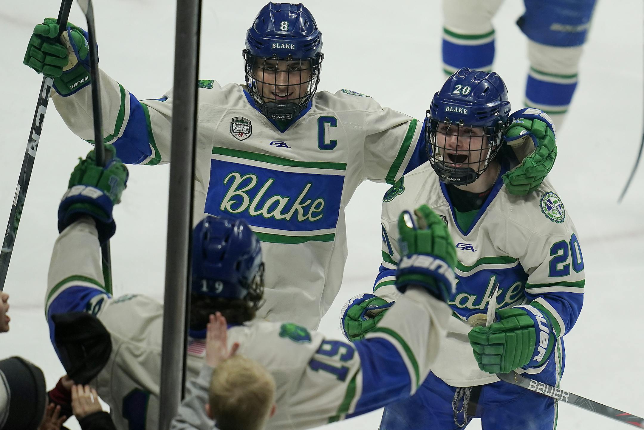 Blake forward Gavin Best, left, and Blake forward Joe Miller, right, celebrated a goal in the third period with Blake defenseman Will Svenddal, bottom. ] LEILA NAVIDI • leila.navidi@startribune.com BACKGROUND INFORMATION: Maple Grove High School played against The Blake School in the 2A boys' hockey state quarterfinal at Xcel Energy Center in St. Paul on Thursday, March 5, 2020. Blake won the game 7-5.
