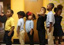 Kindergartners waited in line at Friendship Academy of the Arts in Minneapolis, where the student body is 95 percent black.