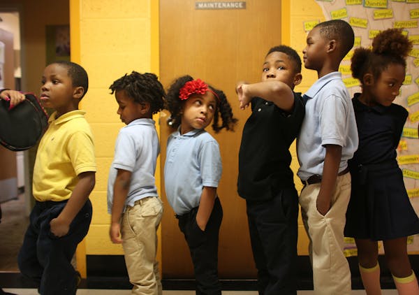 Kindergartners waited in line at Friendship Academy of the Arts in Minneapolis, where the student body is 95 percent black.