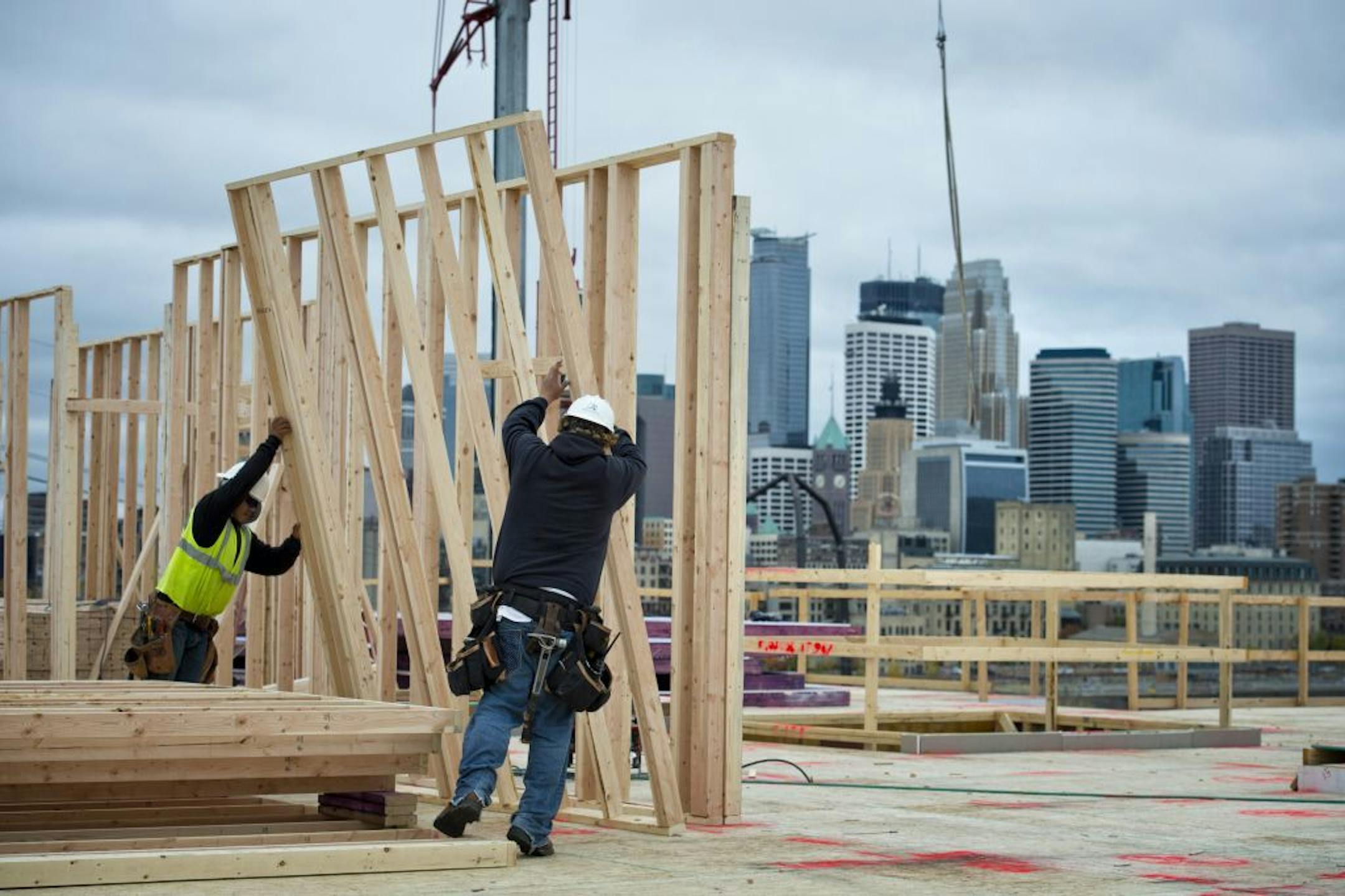 John Eitel and Luis Rodriguez put up wall frames at Mill and Main apartments, 501 Main St. SE. The Commerce Department said Wednesday that home construction rose 15 percent last month to a seasonally adjusted annual rate of 872,000. Apartment building increased 25.1 percent. Wednesday, October 17, 2012
