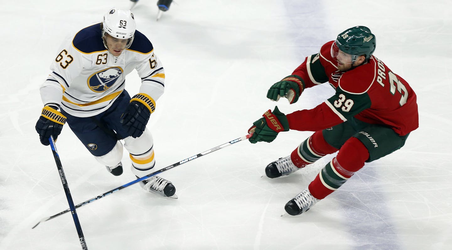 Buffalo Sabres' Tyler Ennis, left, controls the puck against Minnesota Wild's Nate Prosser in the first period of an NHL hockey game Tuesday, Nov. 1, 2016, in St. Paul, Minn. (AP Photo/Stacy Bengs)