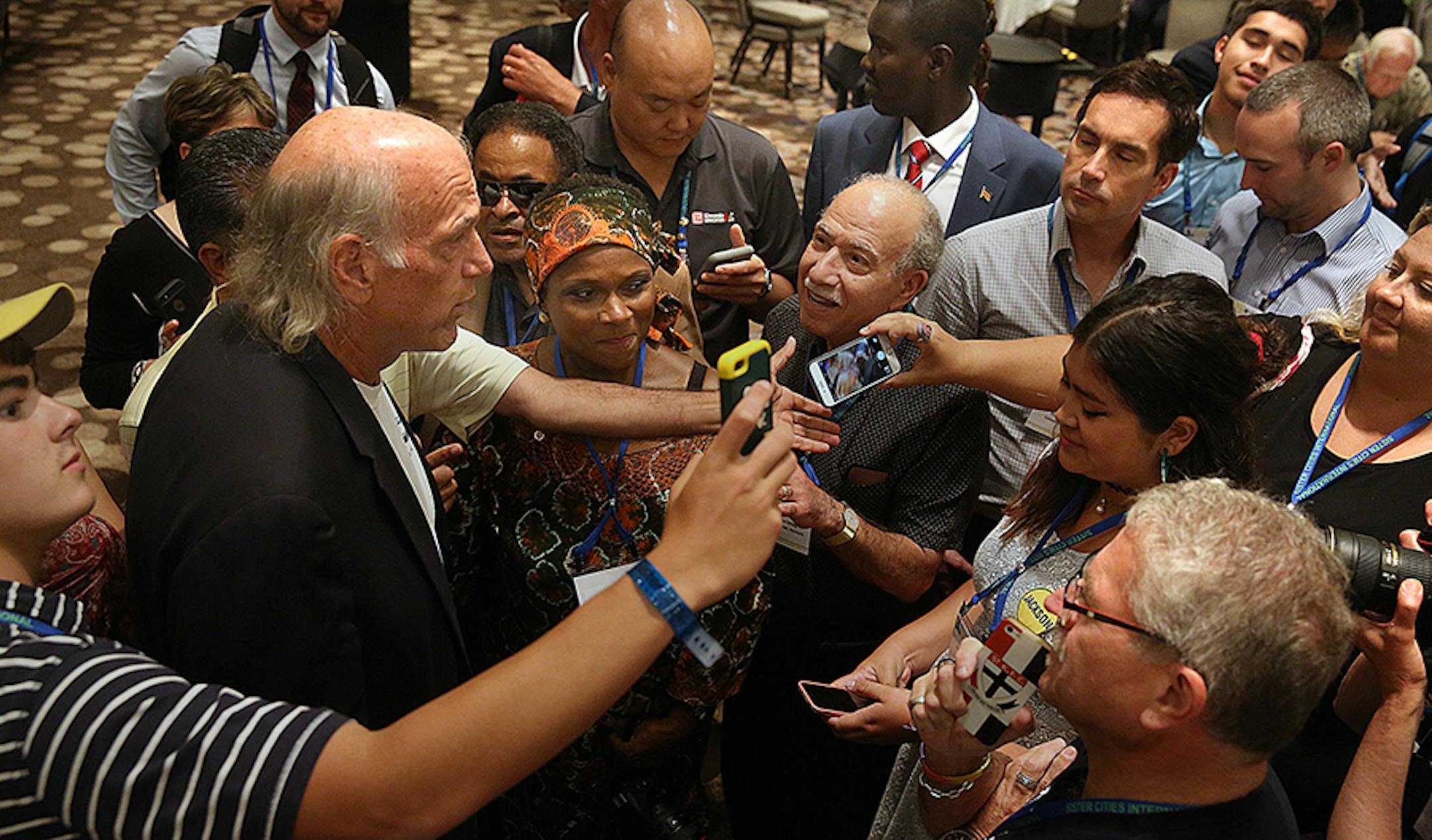 Delegates at the Sister Cities International 59th Annual Conference gathered around former Minnesota Governor Jesse Ventura to ask questions and take photographs. Ventura delivered the luncheon keynote address.