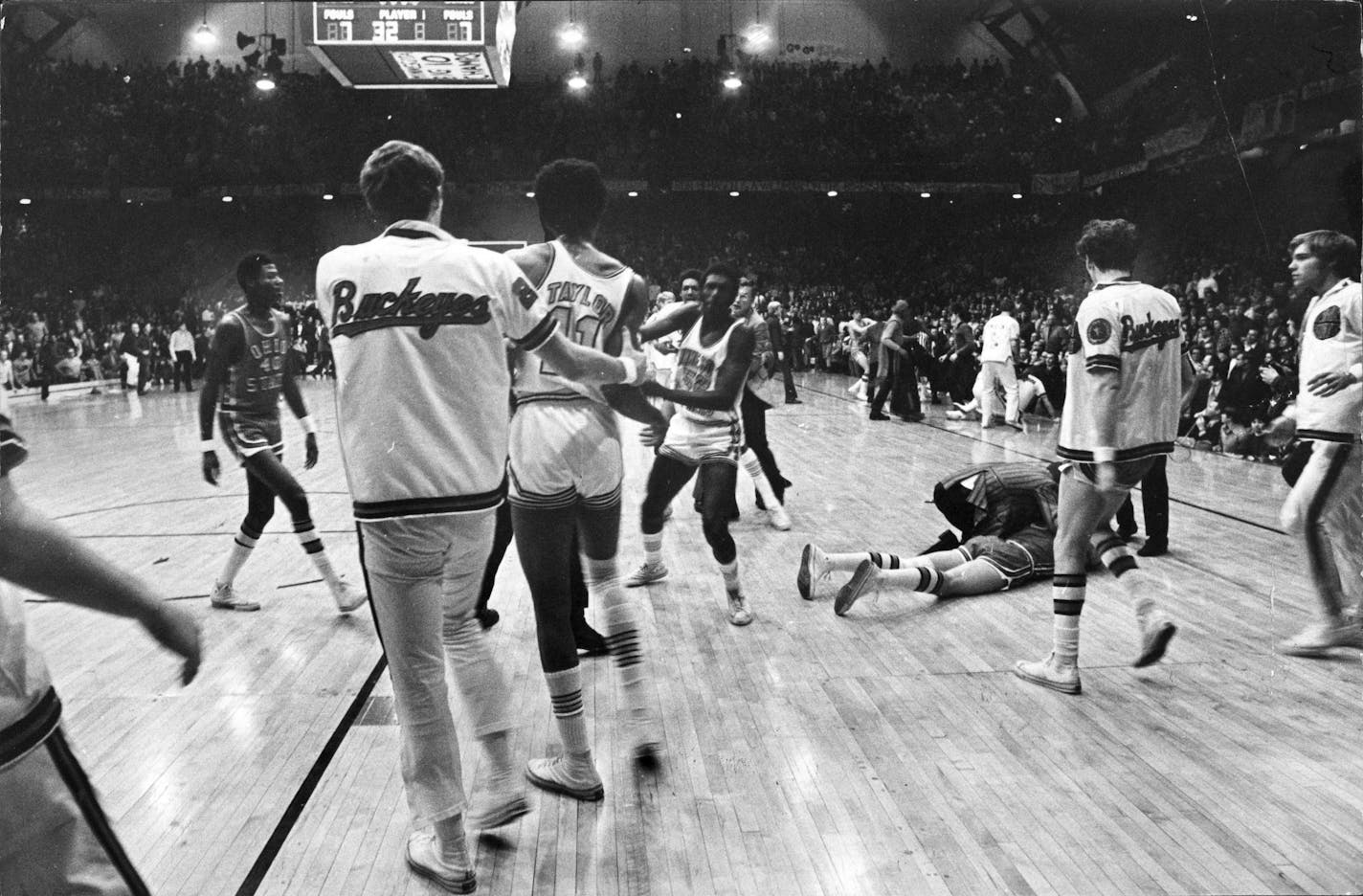 Corky Taylor of Minnesota is pulled away by an Ohio State player after Taylor kneed Luke Witte of Ohio State (on floor) with 36 seconds left in Ohio State's 50 - 44 basketball victory over Minnesota at Williams Arena. Jan. 25, 1972