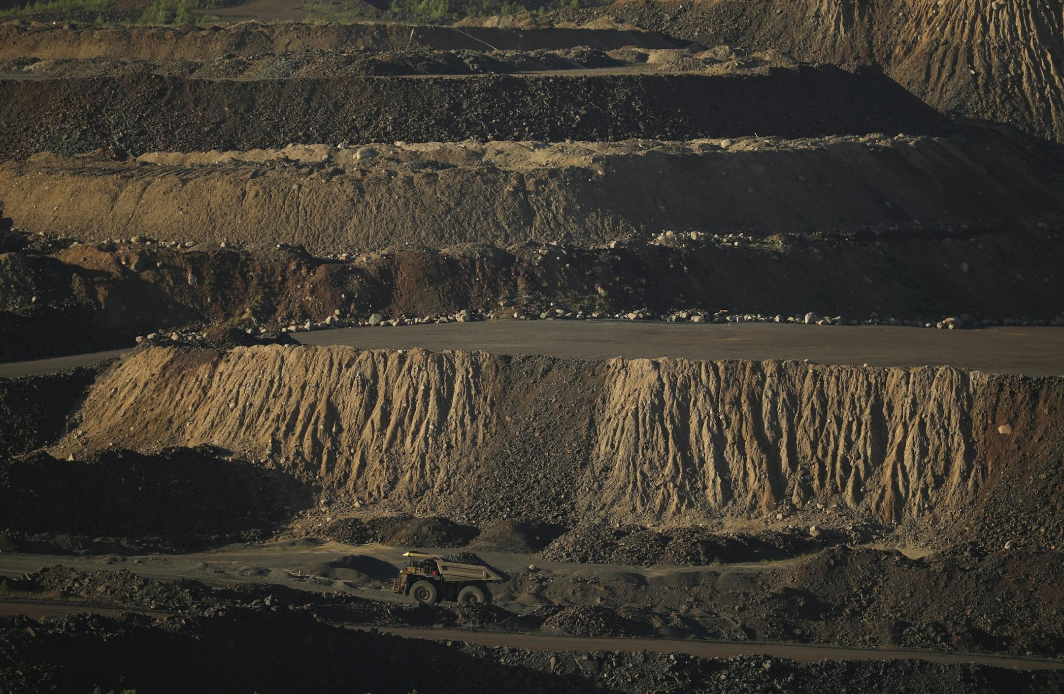 A dump truck transferred a load of ore from one part of the Hull-Rust-Mahoning Mine pit to another Wednesday evening in Hibbing.