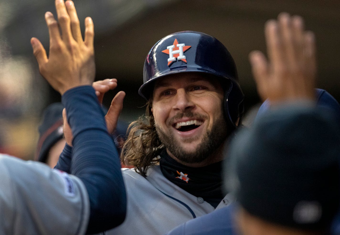 Houston's Jake Marisnick celebrates with teammates in the dugout after scoring in the third inning against the Twins on Tuesday