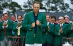 Jordan Spieth beams as he snugs up his green jacket after winning the Masters on Sunday, April 12, 2015, at Augusta National Golf Club in Augusta, Ga.