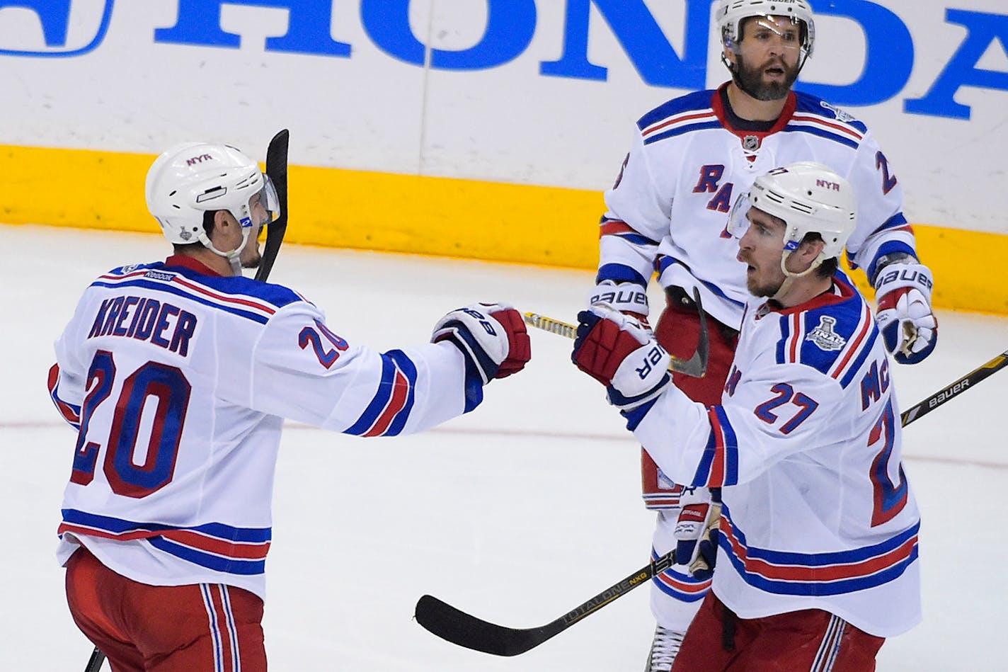 New York Rangers left wing Chris Kreider (20) celebrates his goal, assisted by New York Rangers defenseman Ryan McDonagh (27) while playing the Los Angeles Kings during the second period in Game 5 of the NHL Stanley Cup Final series Friday, June 13, 2014, in Los Angeles. (AP Photo/Mark J. Terrill)