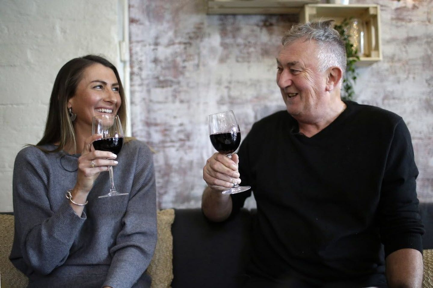 In this Thursday, May 17, 2018, photo, Peter Peacock, 68, right, and Gypsy Diamond, 36, share a laugh over a glass of Shiraz each, their favorite type of wine, in Melbourne, Australia. Peacock, who donated sperm anonymously around 1980, was recently contacted by Diamond, his biological daughter, after a new law in Australia retroactively removed the anonymity granted to sperm donors decades ago.