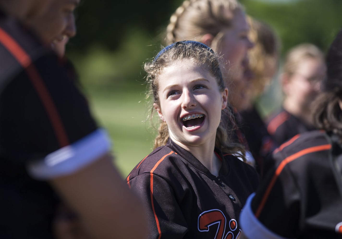 Minneapolis South High School freshman Mia Gerold laughs with teammates during a softball game in Minneapolis. ] (Leila Navidi/Star Tribune) leila.navidi@startribune.com BACKGROUND INFORMATION: During a softball game between South Minneapolis High School and St. Paul Johnson High School Wednesday, May 18, 2016 at Lake Nokomis softball fields in Minneapolis. Chip Scoggins column on Minneapolis South freshman softball player Mia Gerold, who five years ago led the Gophers football team onto the fie