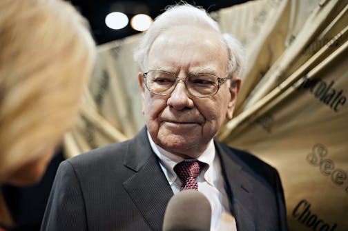 Warren Buffett, chairman of Berkshire Hathaway Inc., tours the exhibition floor prior to the Berkshire Hathaway shareholders meeting in Omaha, Nebraska, U.S., on Saturday, May 3, 2014. Yesterday, Berkshire Hathaway Inc. said first-quarter profit fell 3.8 percent on reduced earnings from Chairman Warren Buffett's derivatives wagers and underwriting at insurance businesses. Photographer: Daniel Acker/Bloomberg Warren Buffett