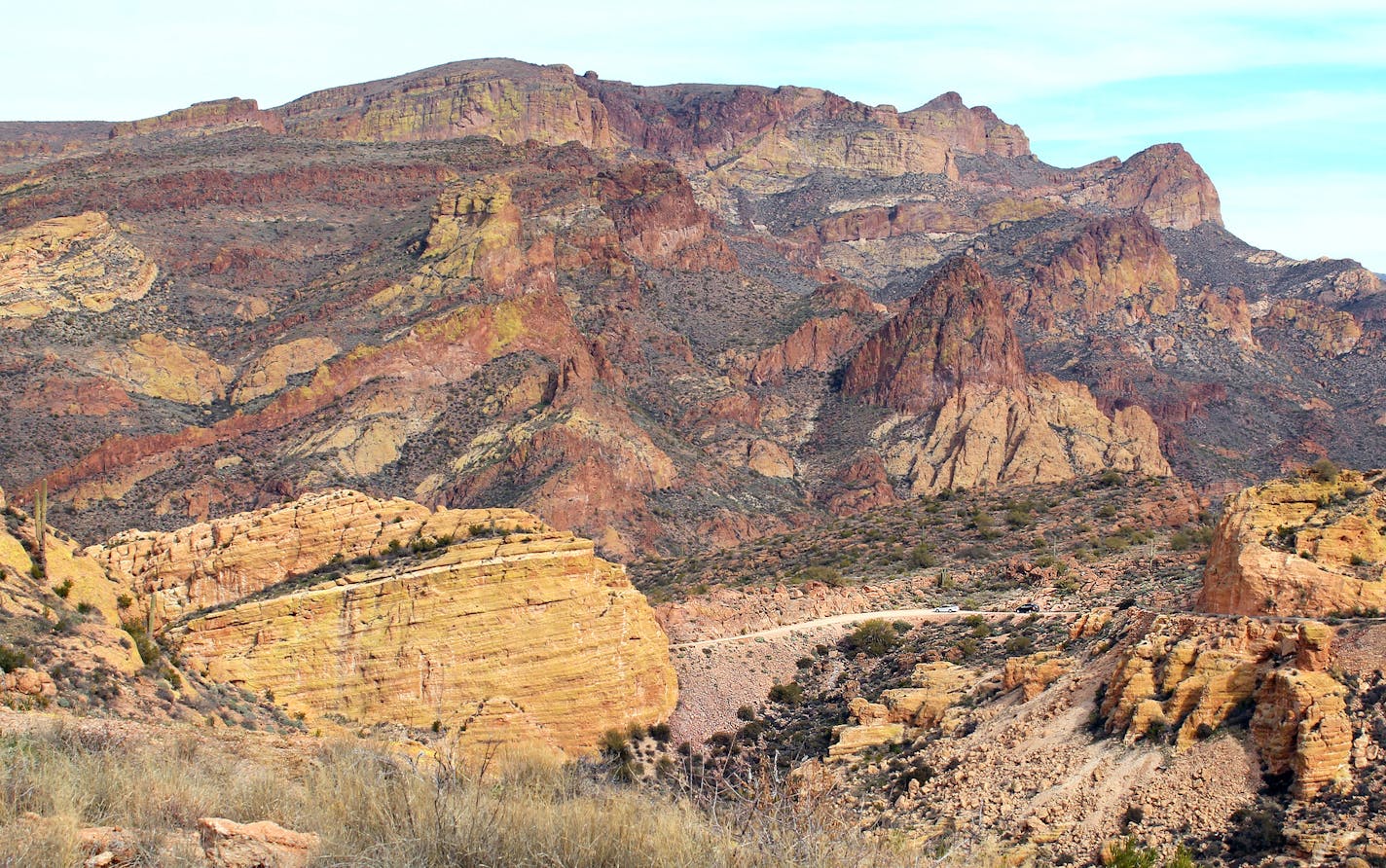 The rocky Arizona landscape dwarfs cars on the Apache Trail, a historic road east of Phoenix. Beyond Tortilla Flat, the road turns to gravel and the drive becomes more rugged.