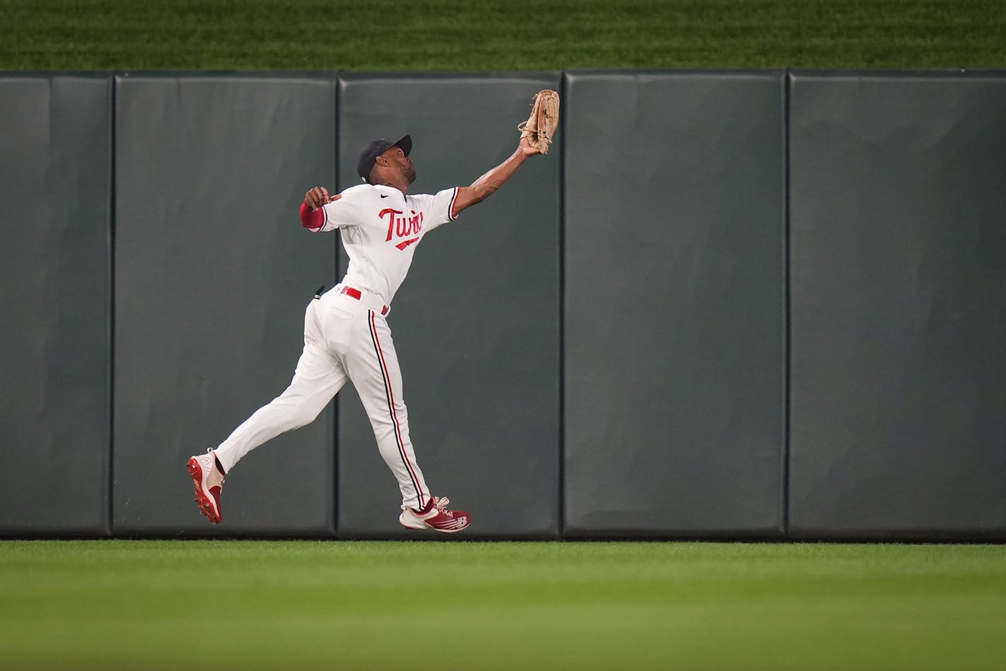 Minnesota Twins center fielder Michael A. Taylor (2) stretches out to catch a fly ball hit by Arizona Diamondbacks left fielder Lourdes Gurriel Jr. (12) in the ninth inning.